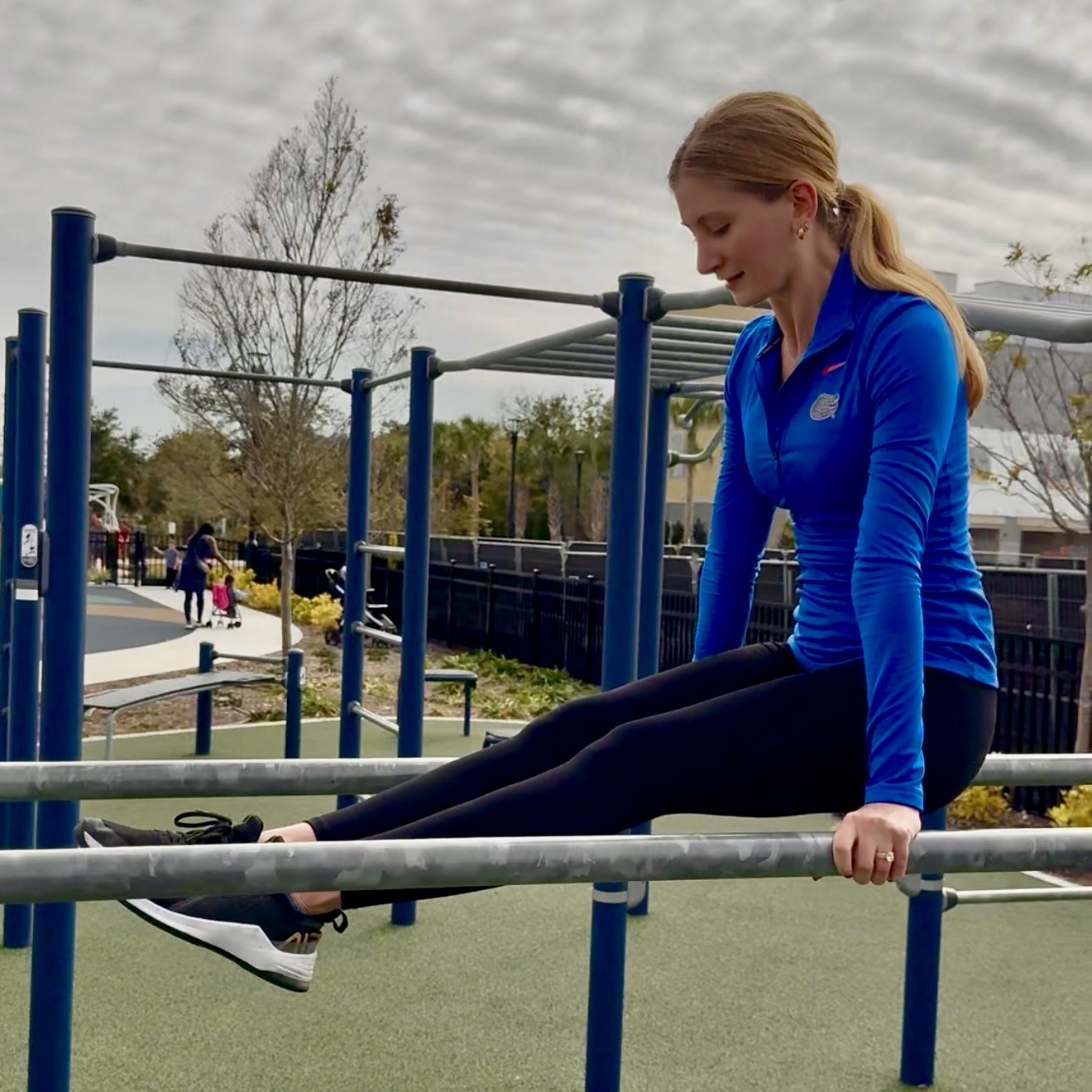 Female JAXTHENX athlete training on bars
