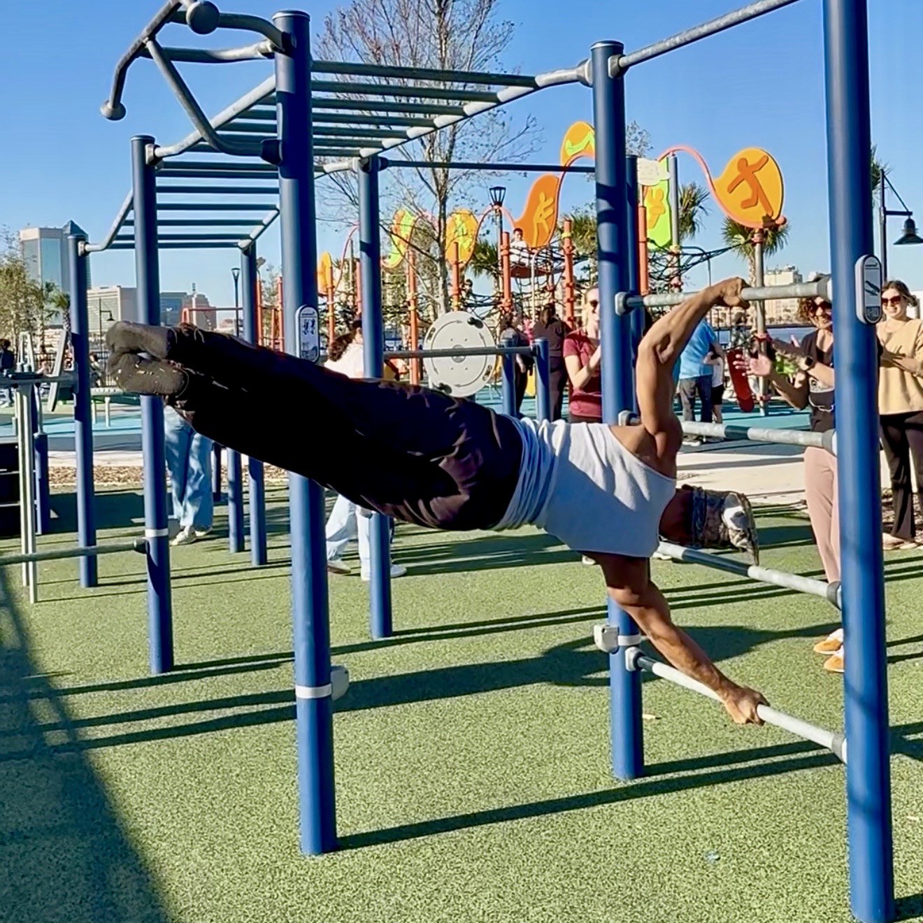 JAXTHENX athlete moving dynamically on bars